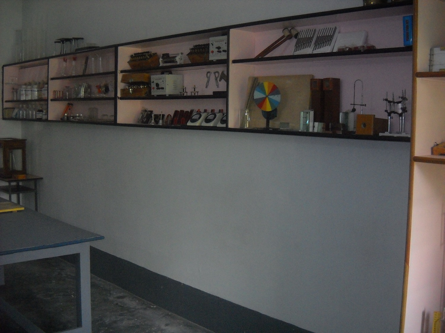 Row of compound microscopes and a sphygmomanometer on the lab table