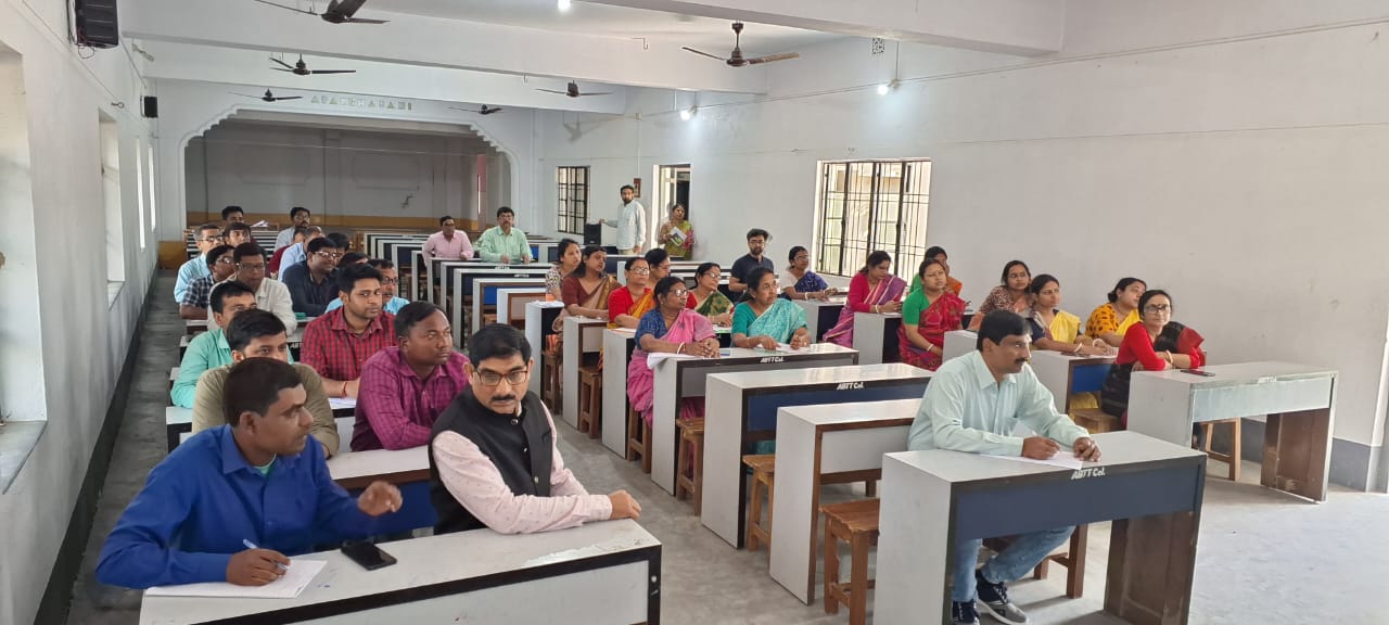 Teachers seated in the college hall during a seminar